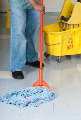 Russell Janitorial LLC janitor in Kensington, CA mopping floor.